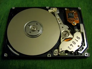 Photo of a metal disk attached to a rectangular electronic device.