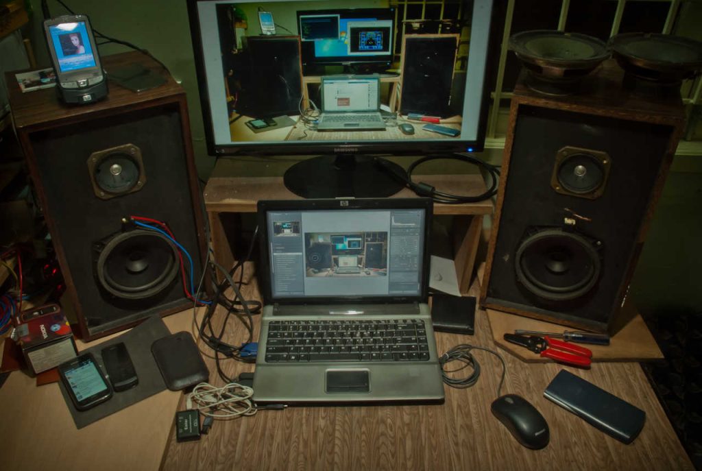 Two audio speakers next to a laptop.