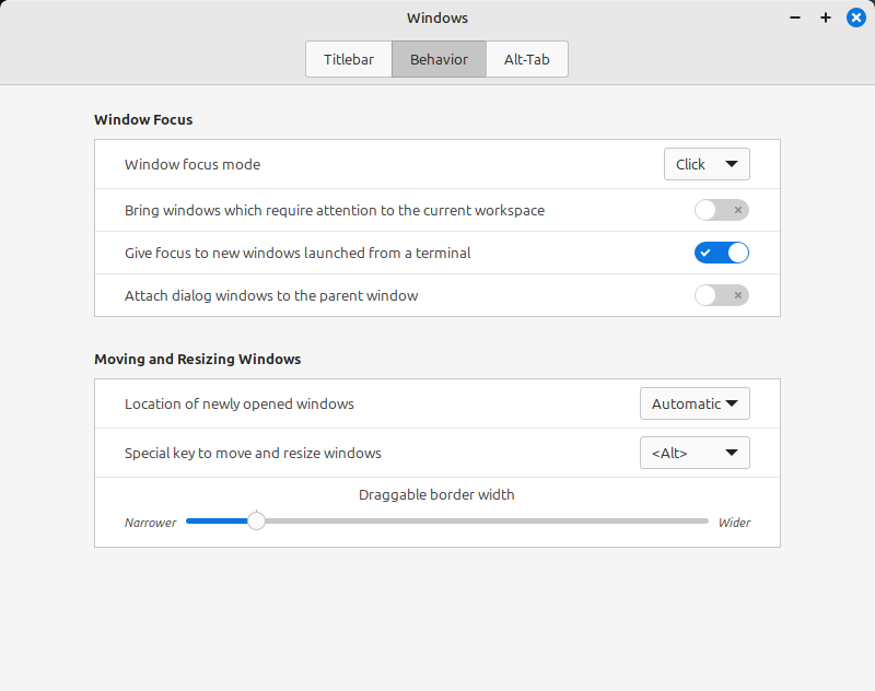 A dialog window titled "Windows." Three tabs on top: Titlebar, Behavior (active), and Alt-Tab. Window Focus section: Window focus mode: set to "click"; Bring windows which require attention to the current workspace: switched off; Give Focus to new windows launched from a terminal: switched on; Attach dialog windows to the parent window: switched off. Moving and Resizing Windows section: location of newly opened windows: atuomatic; spcial key to move and resize windows: ; Draggable border width: more narrower than wider.