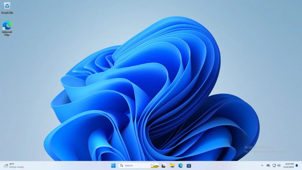 Windows 11's desktop and taskbar. On the desktop, icons for Recycle Bin and Microsoft Edge. On the taskbar, a search box, system clock, and at the bottom-left corner the weather. A watermark for activating Windows appears over the blue-themed wallpaper.