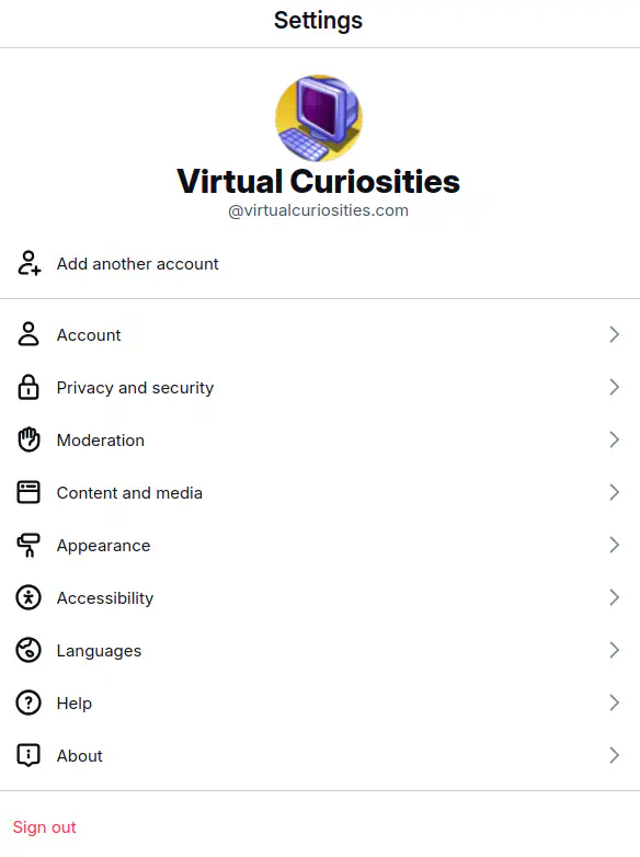 A page titled "Settings" display the avatar of the user @virtualcuriosities.com in its header. Options: Add another account, Account, Privacy and Security, Moderation, Content and media, Appearance, Accessibility, Languages, Help, About, and Sign Out.